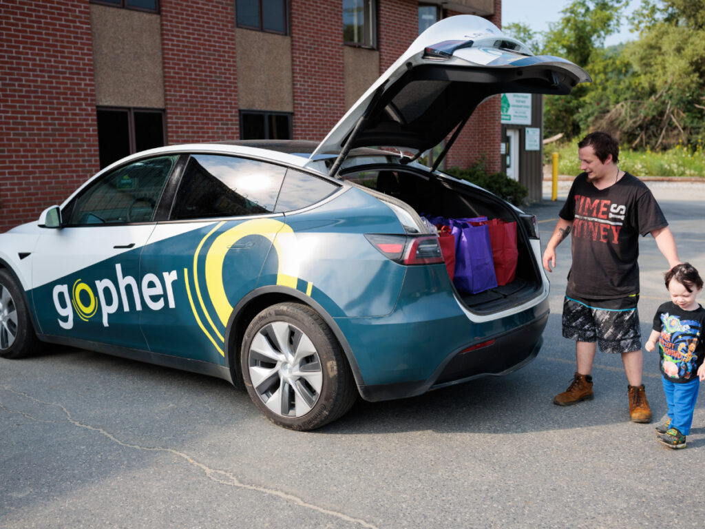 Gopher's Tesla parked and being loaded up by a passenger.